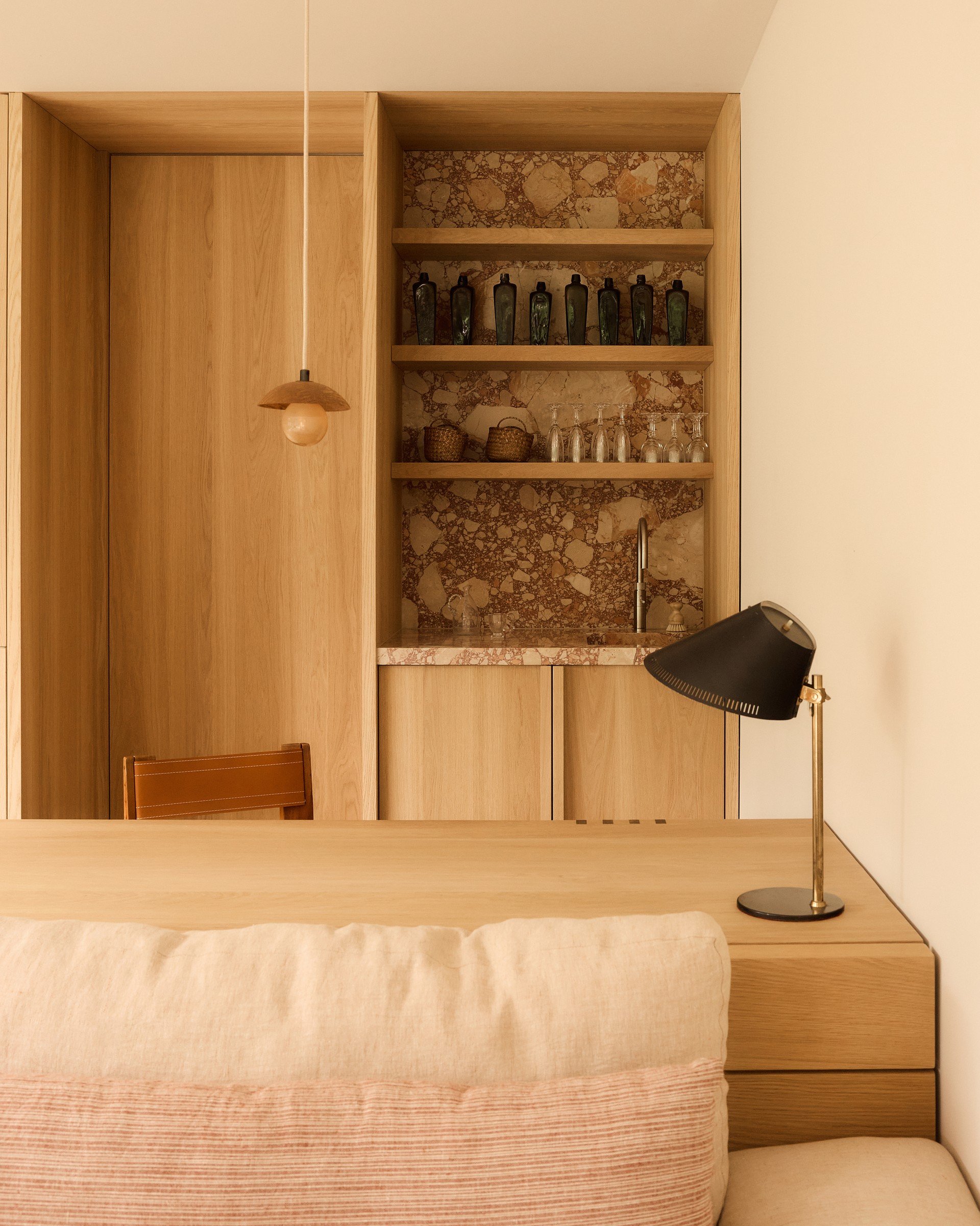 Garden room in Driebergen with custom wooden cabinets and a soft lounge sofa