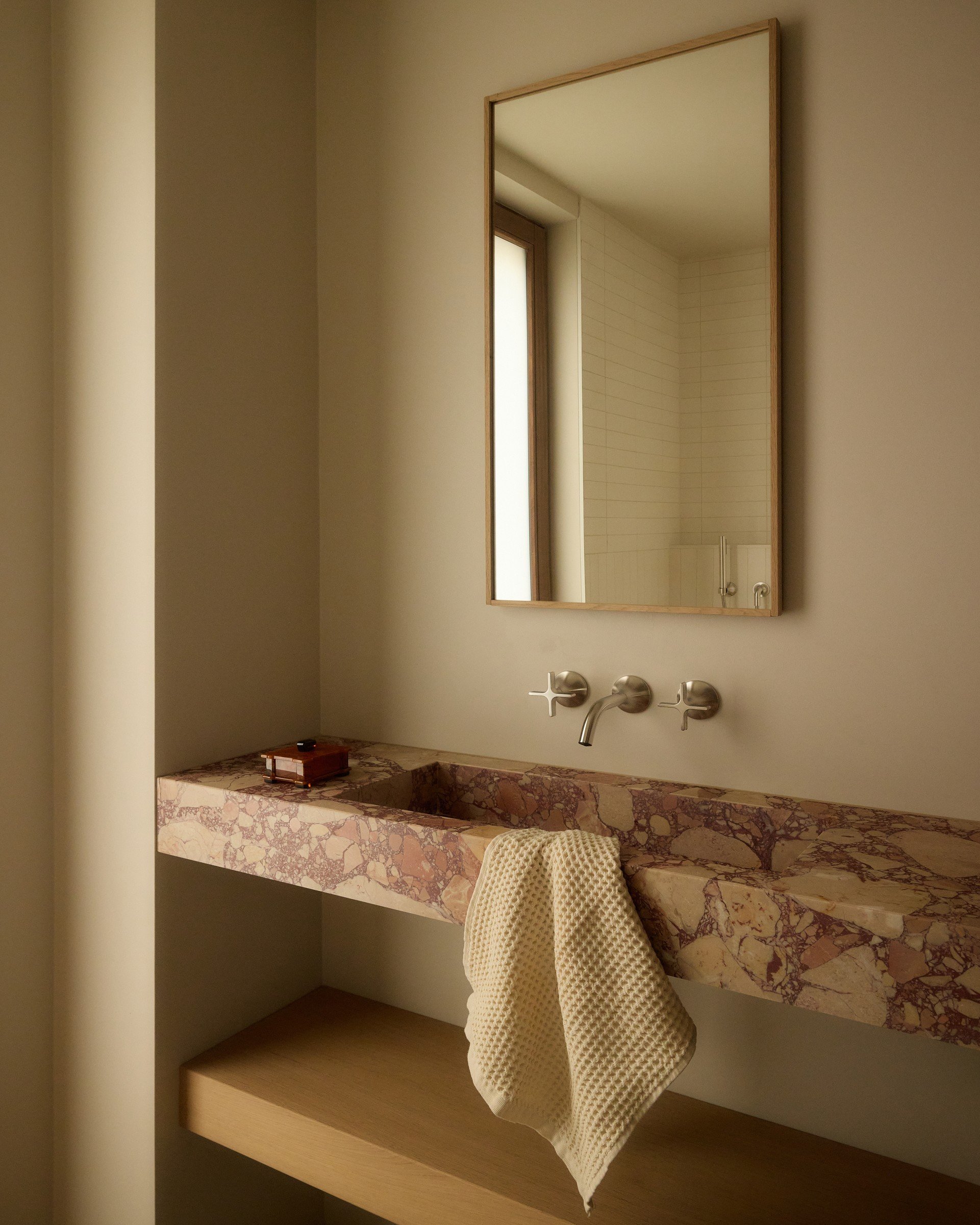 Stone washbasin and mirror in the spa
